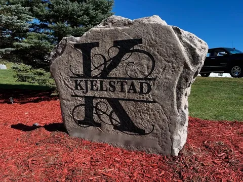 Monogram address boulder in a landscaped bed