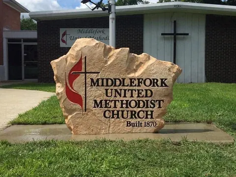 Red rock church boulder sign in front of the church