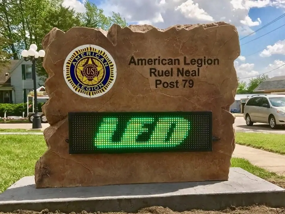 Veterans post boulder sign with a full-color emblem and a built-in LED message board