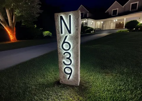Lighted address column boulder at night