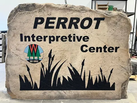 Large engraved boulder sign at a state park