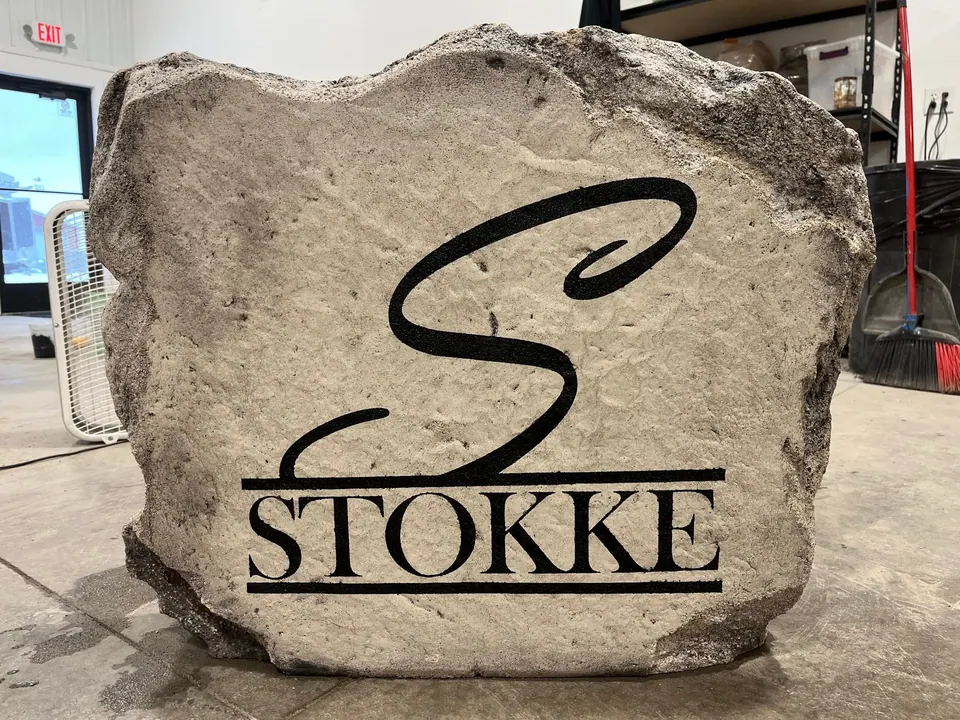 Grey wedding-gift boulder with a script monogram and family name
